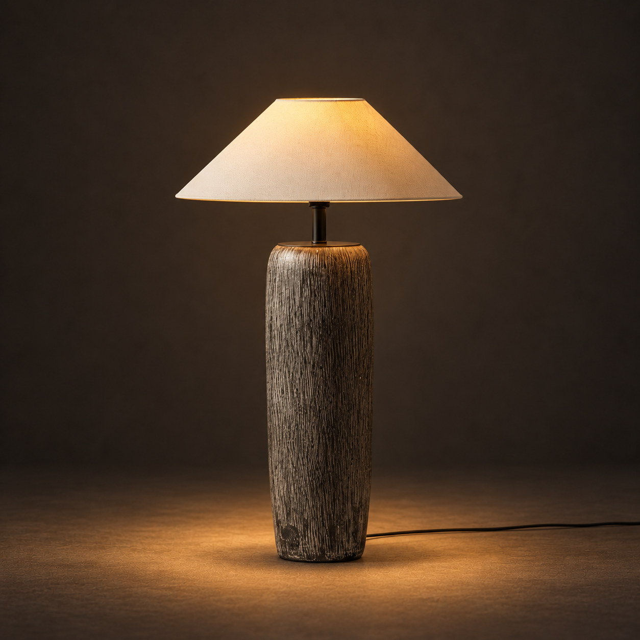 Antrum Table Lamp illuminated against a warm charcoal gallery background