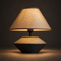 Casa Wabi Sabi table lamp illuminated against a warm charcoal background