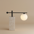 Equilibrium table lamp with travertine base and black steel arm
