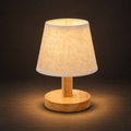 Lignum - Natural Wood Table Lamp illuminated against a warm charcoal gallery background